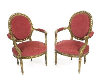 Lot 873 - A pair of Louis XV style fauteuils, each with...