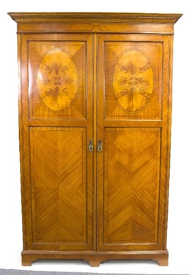 Lot 875 - An Edwardian satinwood wardrobe, the pair of...