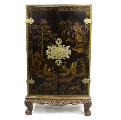 Lot 876 - A black and gold lacquer cabinet with...