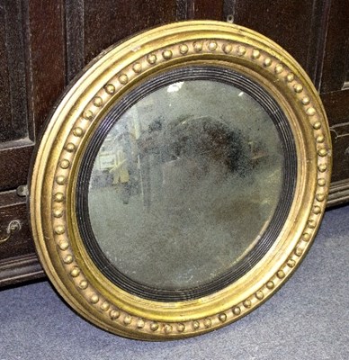 Lot 884 - A Regency convex wall mirror in a gilt ball...