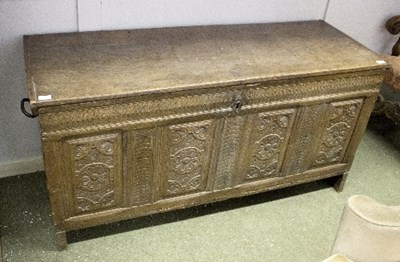 Lot 953 - An oak coffer with carved panel front, hinged...