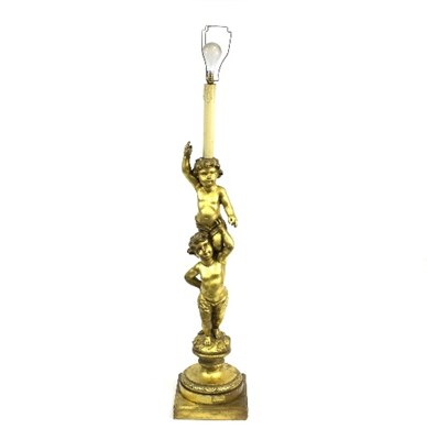 Lot 968 - A carved giltwood standard lamp modelled as a...