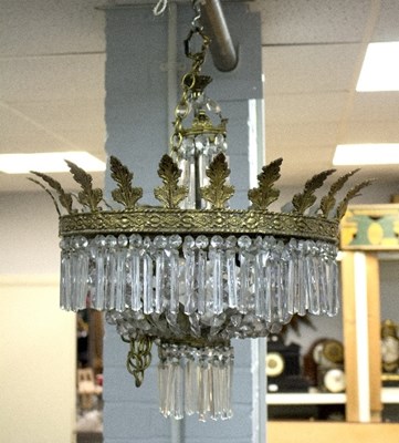 Lot 973 - A gilt metal and crystal chandelier with...