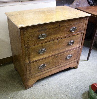 Lot 983 - An oak chest of three drawers, the fronts...