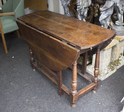 Lot 1001 - An 18th Century oak drop leaf table on...