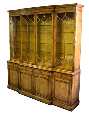 Lot 1017 - A reproduction breakfront bookcase, enclosed...