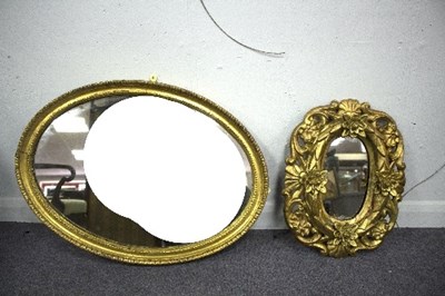 Lot 1020 - An oval giltwood framed mirror and another...