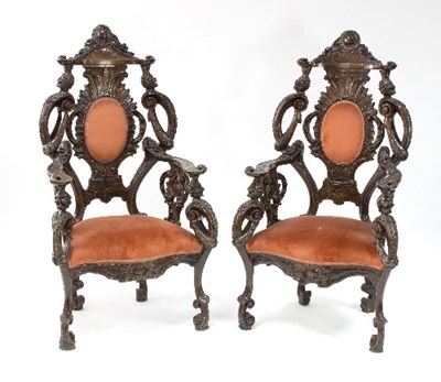 Lot 1031 - A pair of Venetian carved walnut armchairs...