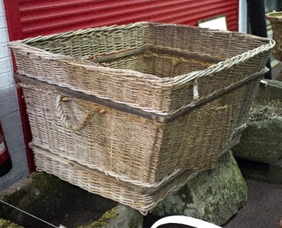 Lot 1073 - A large wicker log basket with rope carry...