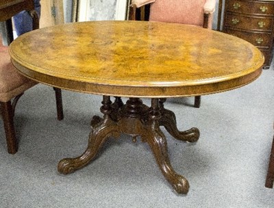 Lot 1084 - A Victorian walnut loo table, the oval top...