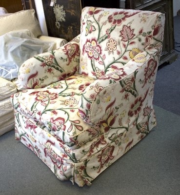 Lot 1088 - An upholstered armchair with floral loose cover