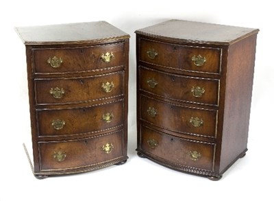 Lot 1093 - A pair of walnut bowfront bedside chests, each...