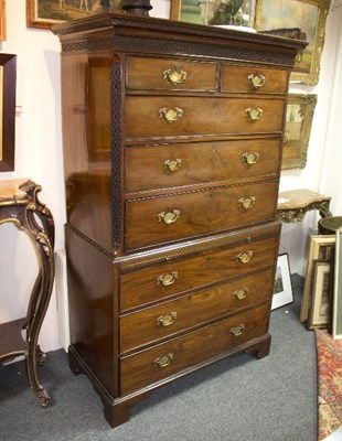 Lot 1097 - A late George III figured mahogany chest on...