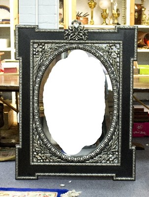 Lot 1113 - A modern wall mirror, the oval plate beneath a...