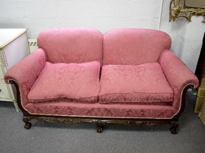 Lot 1115 - An upholstered two-seater sofa with carved...