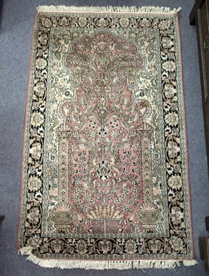 Lot 1130 - A Persian rug, decorated with scrolling floral...