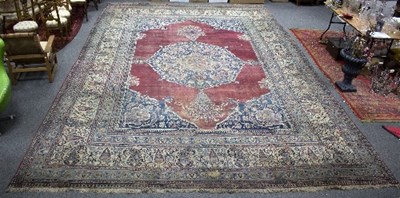 Lot 1133 - A large Indian carpet with central blue ground,...