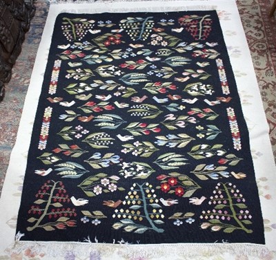 Lot 1147 - A needlework rug decorated birds and flowers...