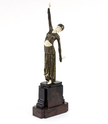 Lot 1152 - A resin and spelter Art Deco style figure in...