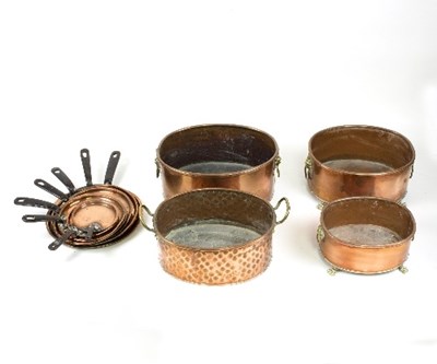 Lot 1256 - A set of eight graduated copper pan covers and...