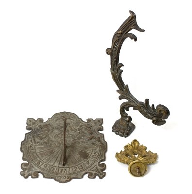 Lot 1282 - A wall mounted brass sundial, 28cm wide and...