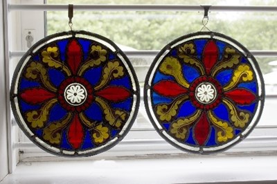 Lot 1294 - A pair of Edwardian circular stained glass...