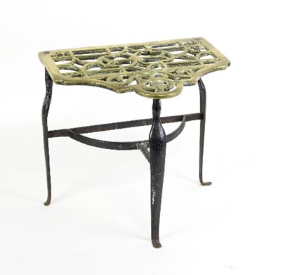 Lot 1304 - A George III pierced brass trivet on an iron...