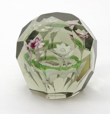 Lot 33 - A 19th Century faceted glass paperweight, with...