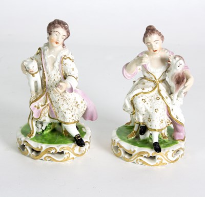 Lot 123 - A pair of Derby seated figures with a cat and...