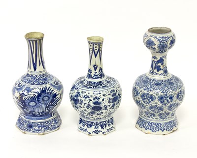 Lot 166 - Three Delft blue and white bottle vases of...