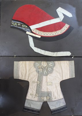 Lot 259 - A Oriental silk red winter hood, framed and...