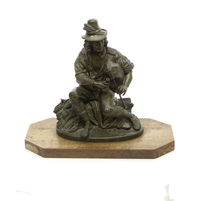 Lot 425 - A bronze figure of an Irish piper, seated on a...