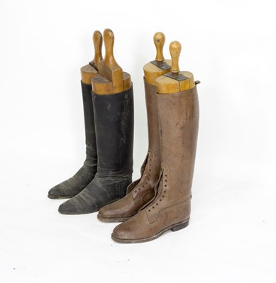 Lot 437 - Two pairs of leather riding boots with wooden...