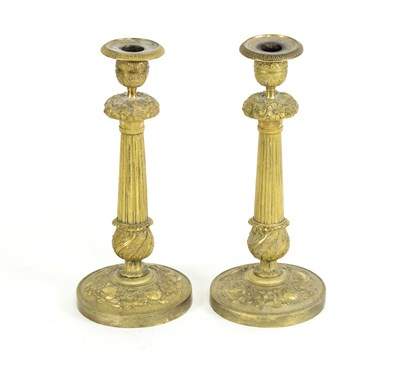 Lot 482 - A pair of gilt metal candlesticks, each of...