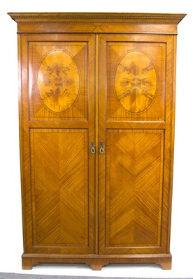 Lot 563 - An Edwardian satinwood wardrobe, the pair of...