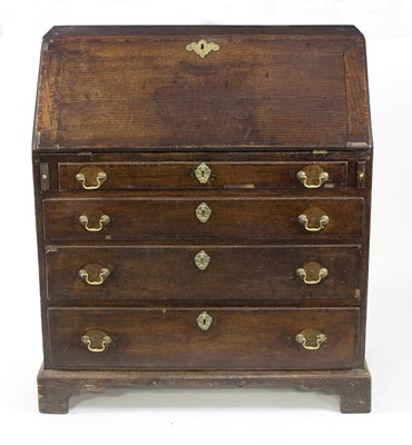 Lot 575 - A George III oak bureau, the fitted interior...