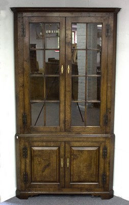 Lot 606 - An oak corner cupboard by Bylaws, enclosed by...