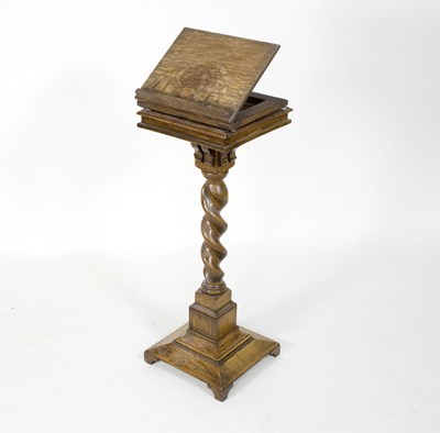 Lot 621 - An oak reading stand on a spiral column and...