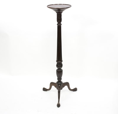 Lot 630 - A mahogany torchere on a fluted column and...