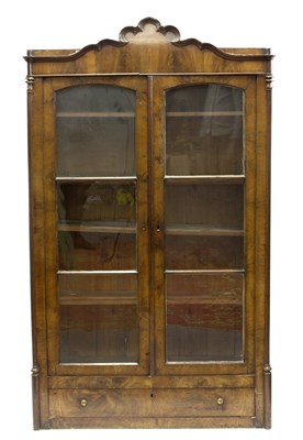 Lot 644 - A Regency mahogany arch top cabinet enclosed...