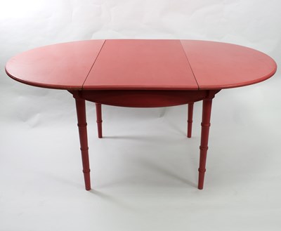 Lot 665 - A red painted circular kitchen table on bamboo...