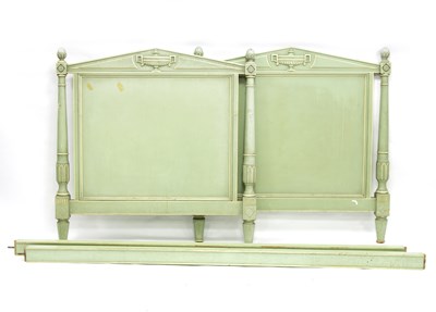 Lot 675 - A French green and white painted bed with...