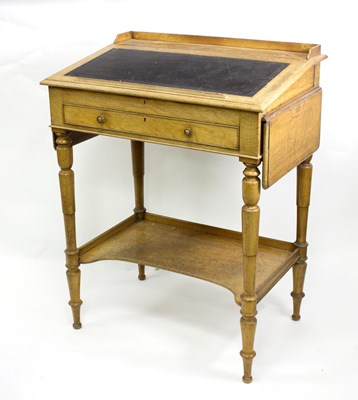 Lot 691 - An oak rent desk with writing slope, drawer...