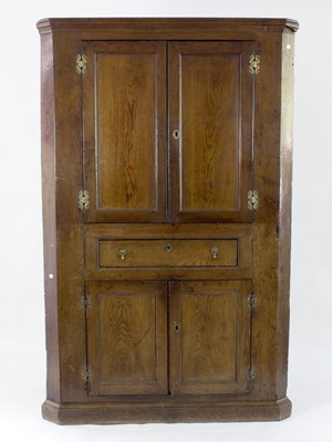 Lot 720 - A George III oak floor standing corner...