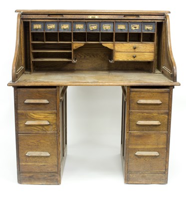 Lot 795 - An American style roll top desk with fitted...