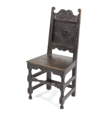 Lot 810 - An oak side chair carved with birds to the...