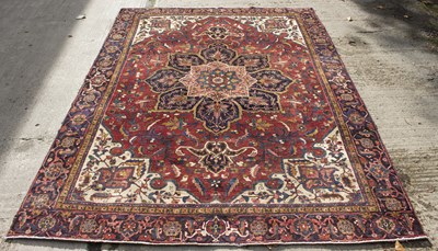 Lot 853 - A carpet of Eastern design with allover red...