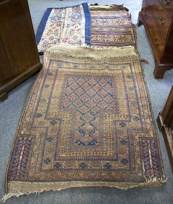 Lot 856 - An Eastern rug and two saddle bags