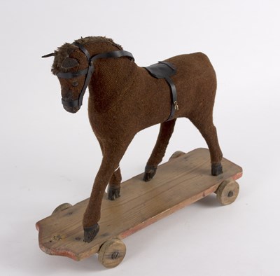 Lot 275 - A child's pull-a-long horse, material covered...