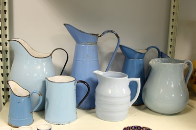 Lot 333 - Six blue enamel jugs and two pottery examples